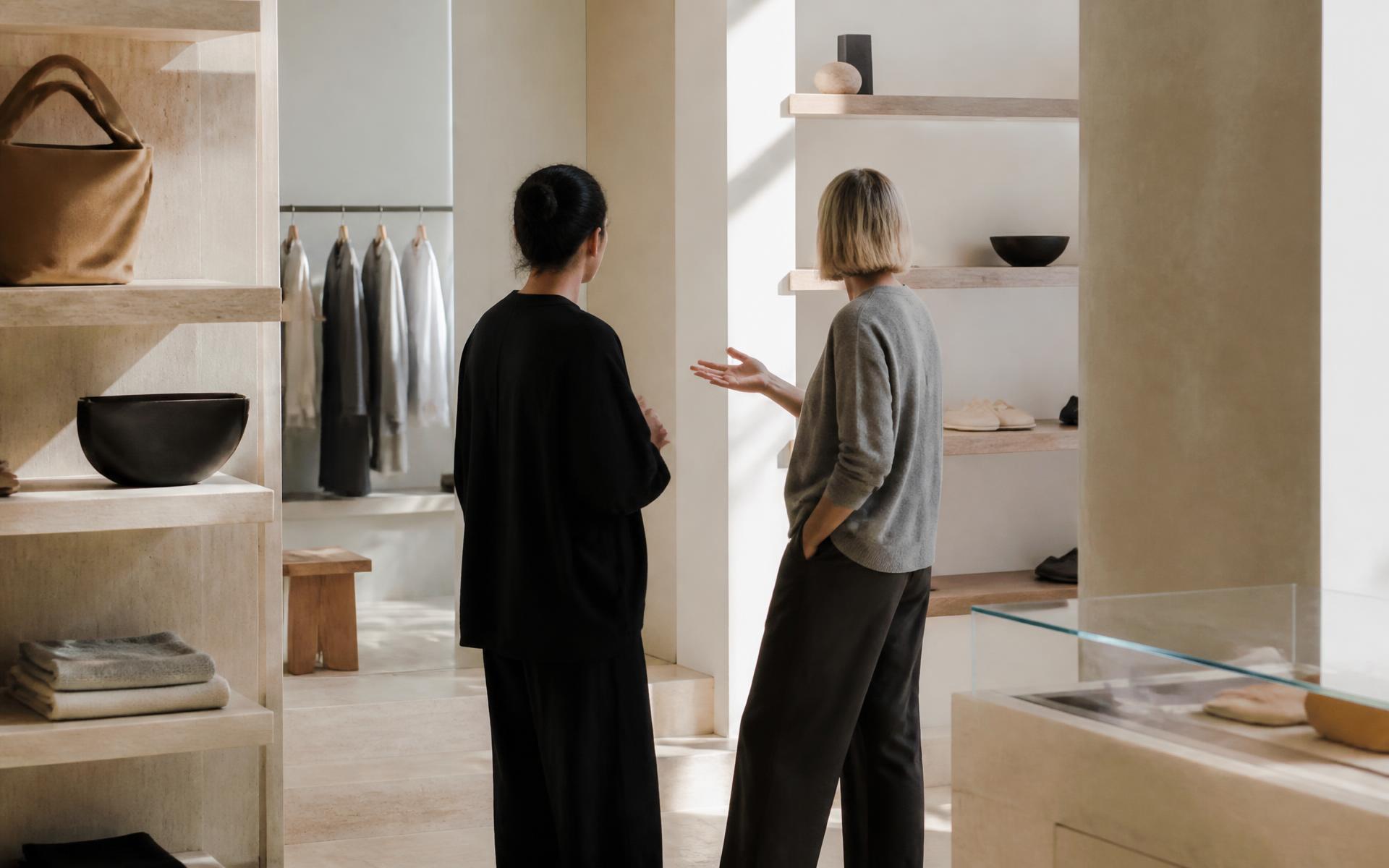 Two team members in conversation on a sunlit flagship floor